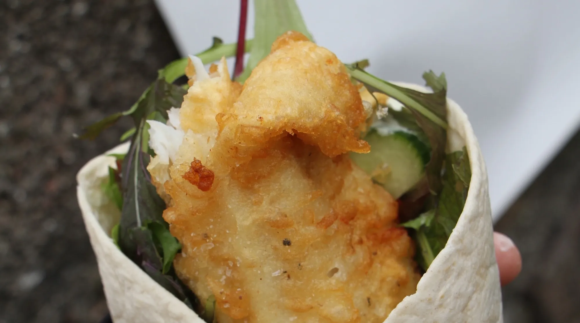 Battered fish in a flatbread wrap with salad